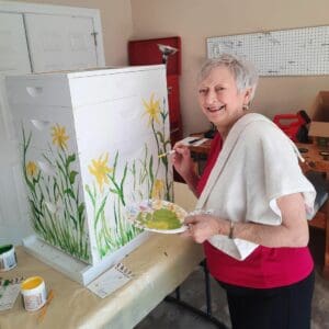 resident painting a hive