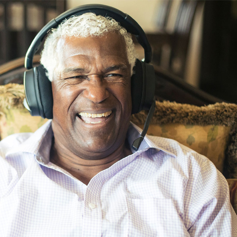 Senior man listening to music with headphones