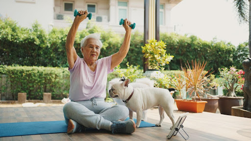 senior working our with her french bull dog