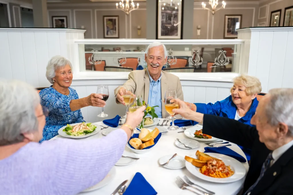Residents of Brandon Wilde dining & toasting to the great senior living amenities in Evans, GA.