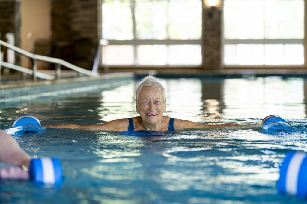 A resident of Brandon Wilde enjoying the pool, one of the many great senior living amenities in Evans, GA.