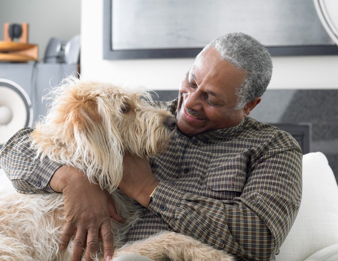 Senior man relaxing with dog at home
