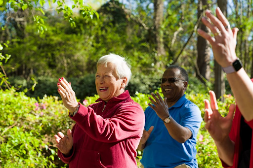 Seniors Smiling and Clapping Outside