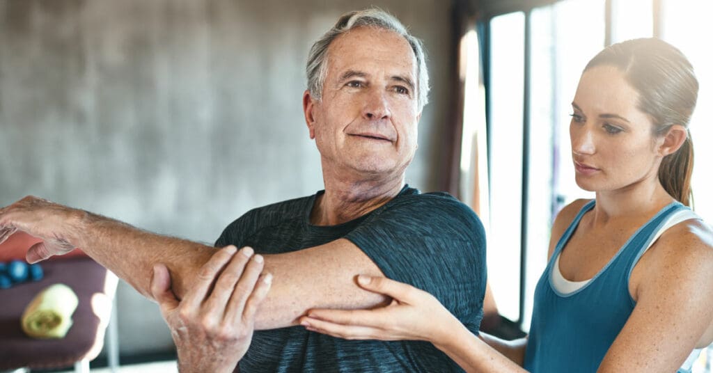 Senior man doing physical therapy exercises