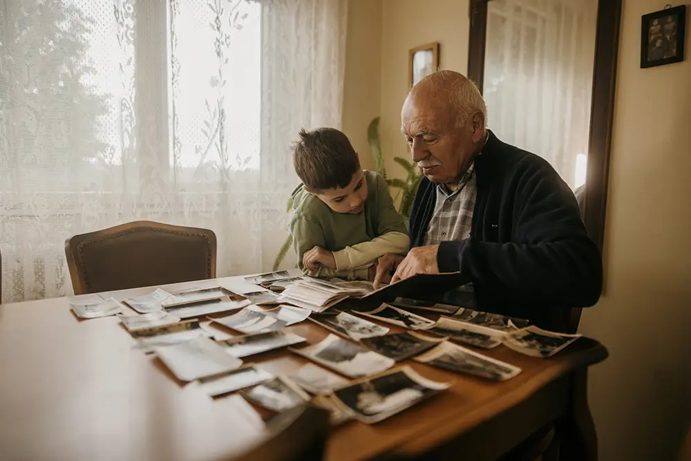 Senior Man Looking at Photos with Grandson