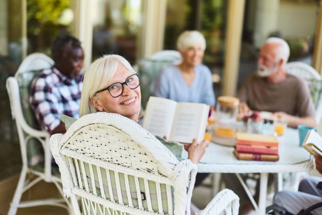 Senior woman reading with friends