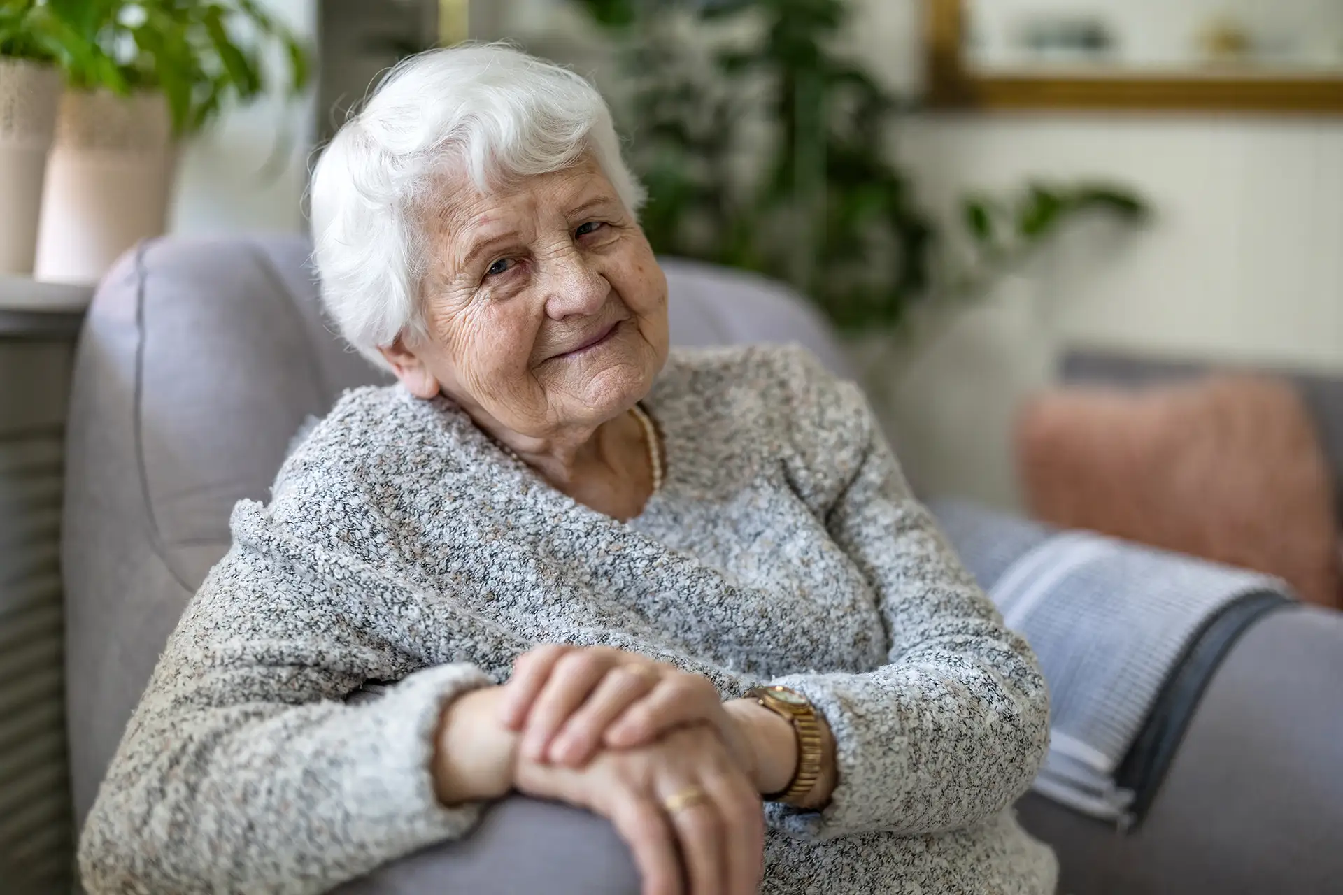 Senior woman smiling in an armchair