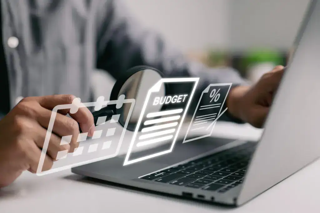 An image of a man on a laptop with icons reflecting budgeting and retirement planning tips for seniors at Brandon Wilde in Evans, GA.