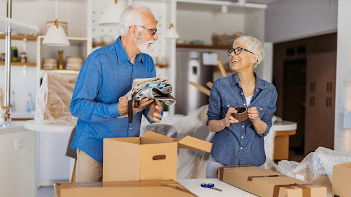 Couple completing the downsizing checklist for seniors by packing up their home
