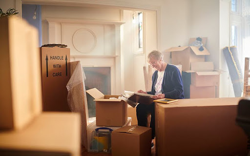 senior woman looks through some memories just before the house move begins