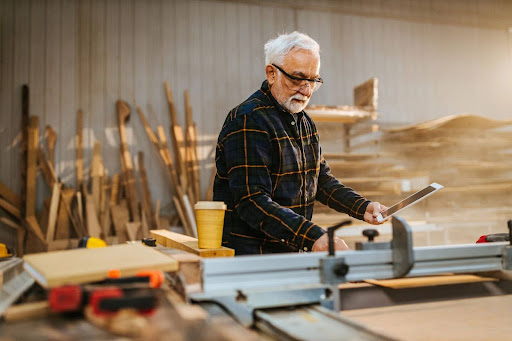 senior man in wood working shop