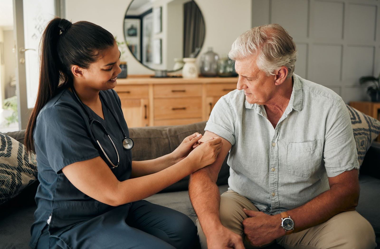 senior man receiving vaccine from caregiver