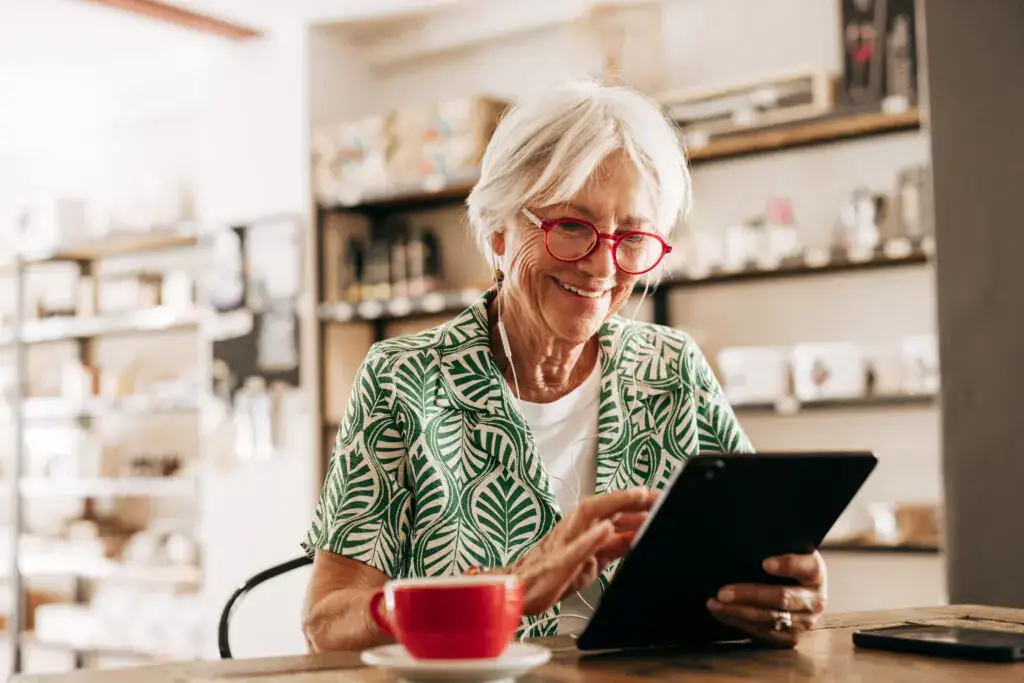 Senior woman on a tablet exploring video calling systems for seniors.